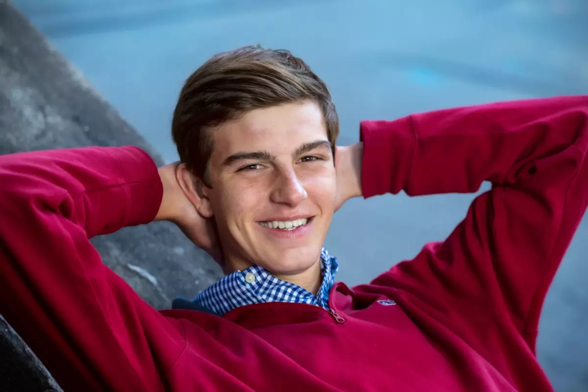 high school boy wearing red sweater photographed in portland maine for senior portrait