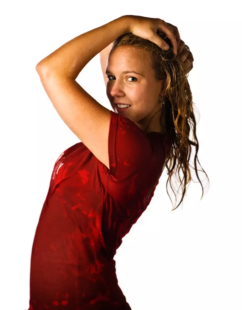 high school girl with water pouring on her for senior pictures in maine
