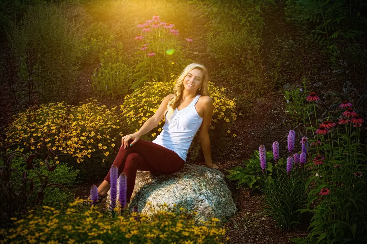 scarborough high school girl at park in flowers for senior pictures in maine