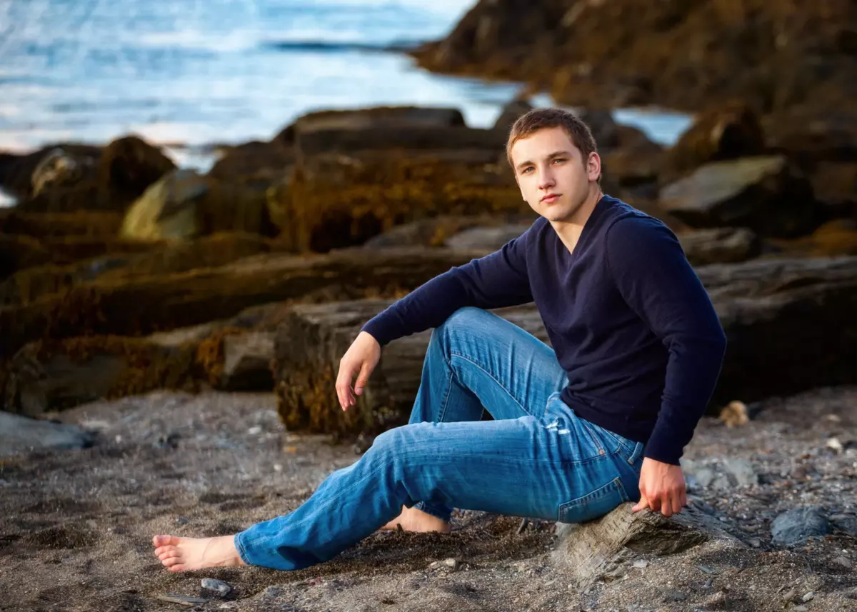 scarborough high school senior boy photographed at the beach in maine for graduation pictures