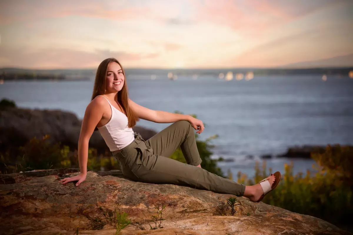 senior high school girl from south portland at beach on rocks with sunset