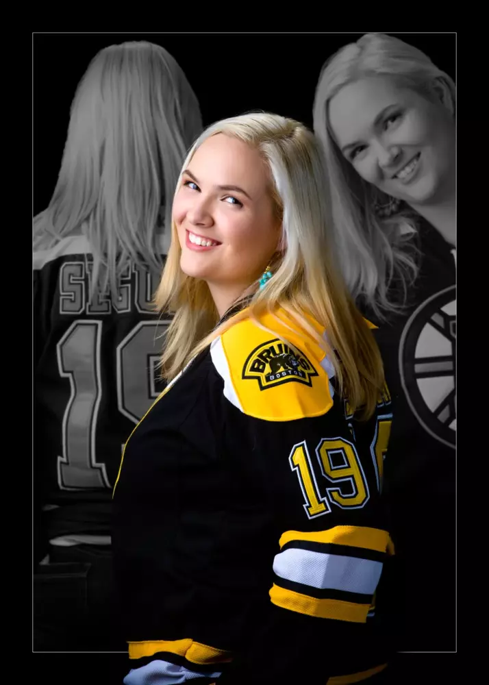 senior picture of girl wearing hockey jersey photographed in maine