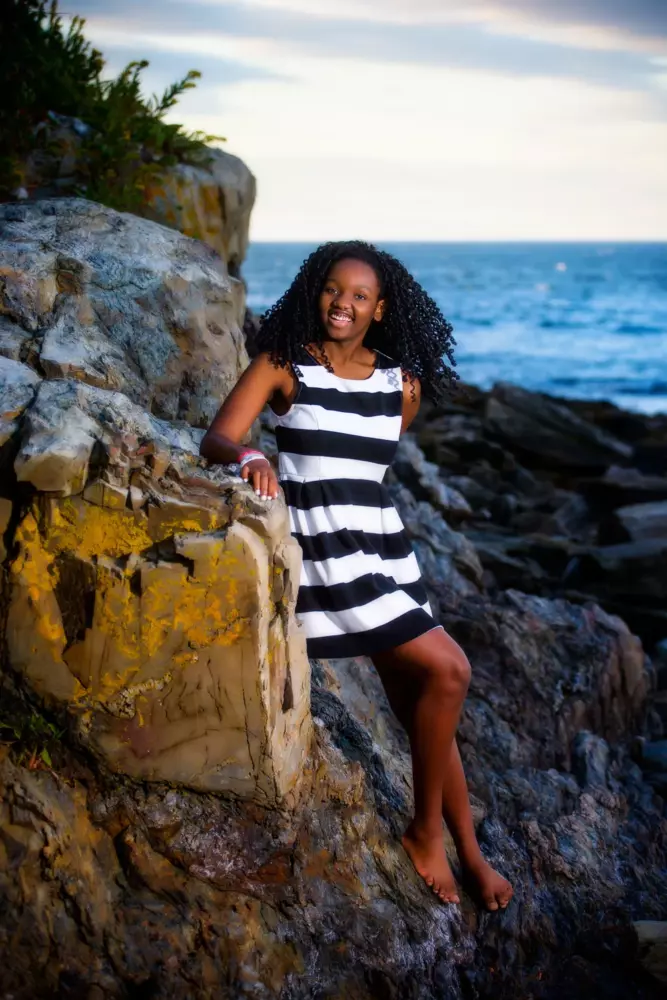 senior pictures of african american girl in striped dress at beach in maine