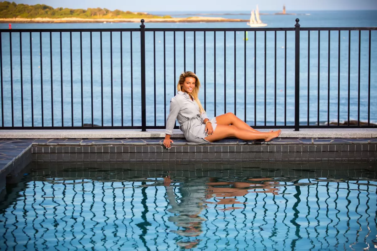 senior portrait created at pool over harbor at home in maine