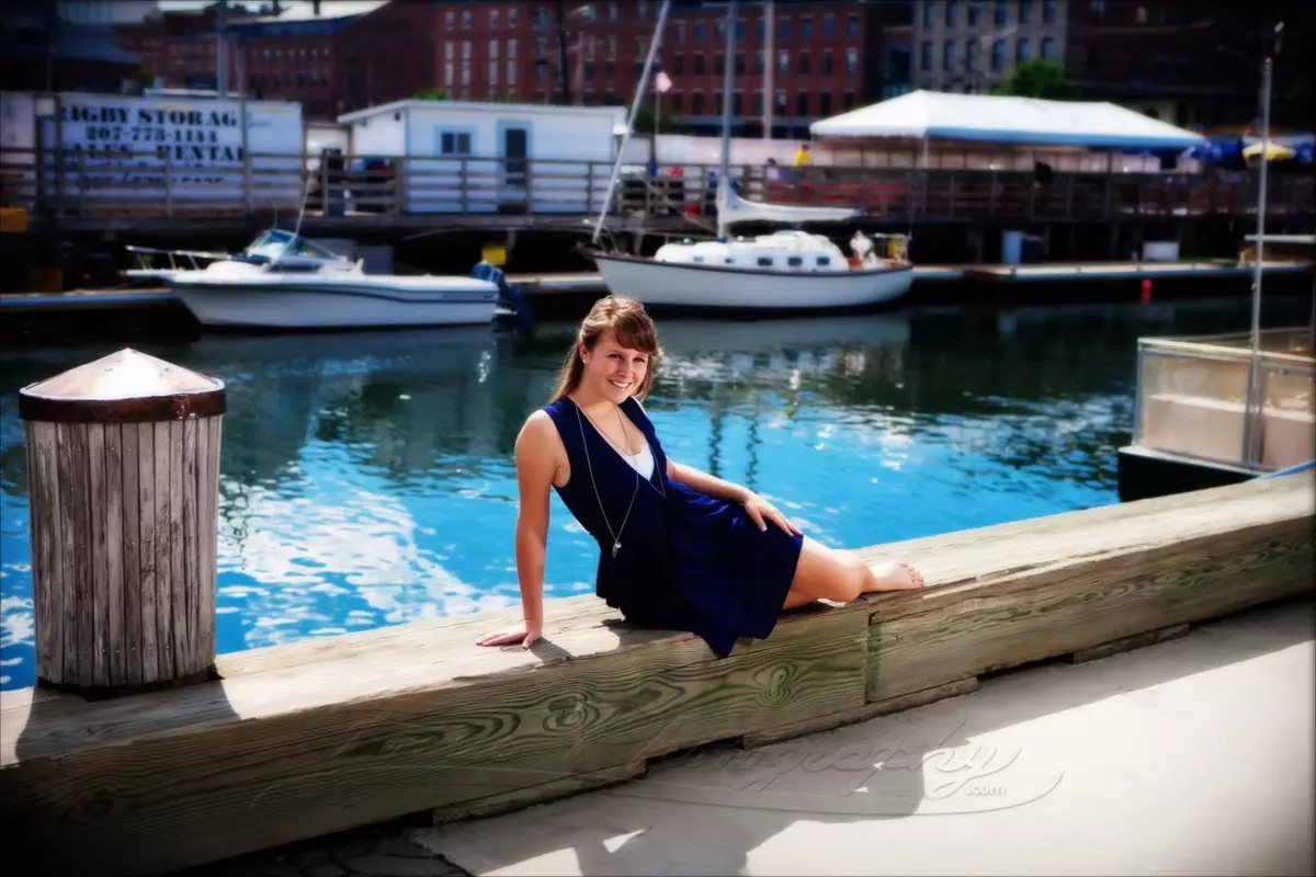 waterfront dock of portland maine with girl in dress for senior pictures