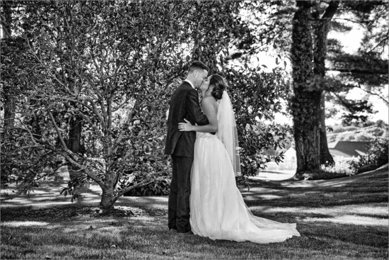 black and white kiss photo in gardens