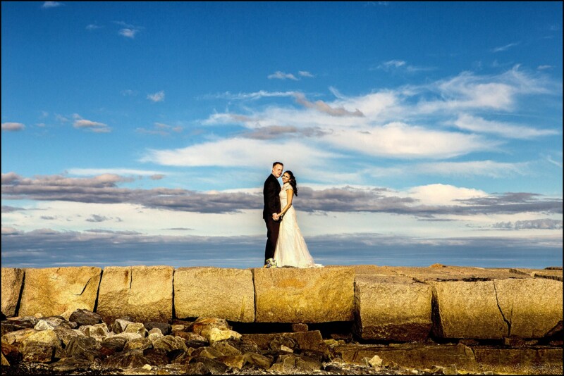 bride and groom on breakwater