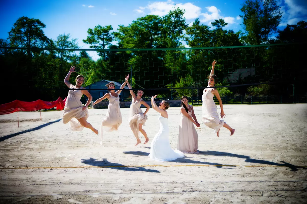 Bridal party jumps volleyball point sebago wedding maine