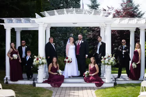 wedding party at gazebo structure in Maine wedding gives testimonial for focus photography