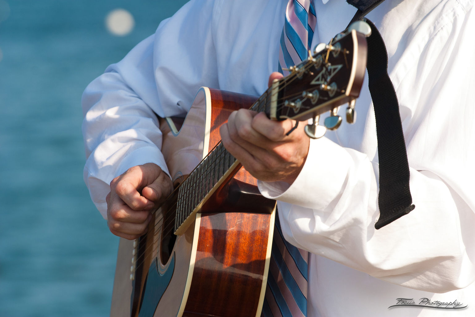 Playing guitar at Casco Bay Maine wedding