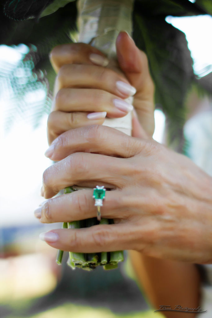 Bride with emerald ring holding her bouquet