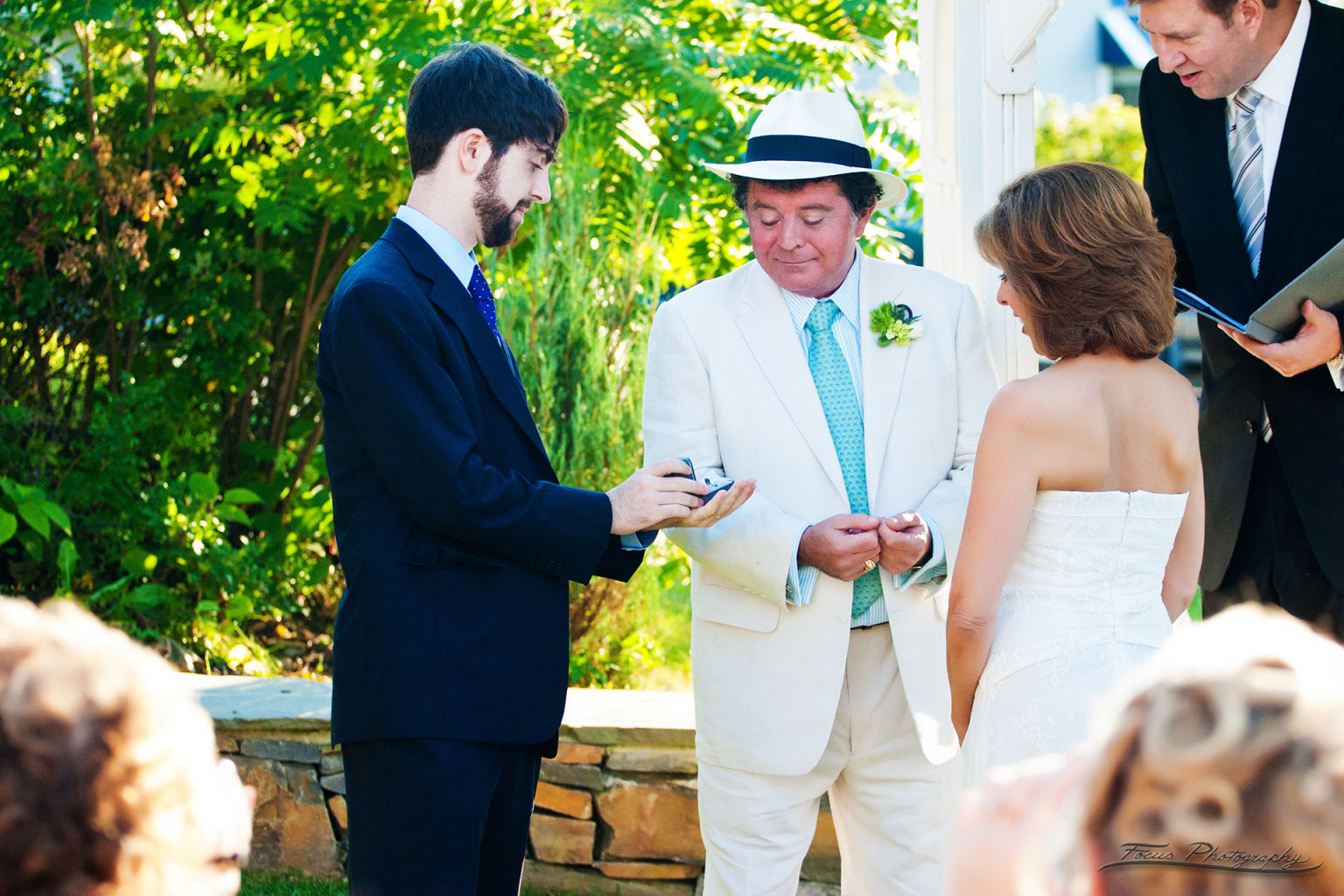 Presenting ring to bride and groom at Maine wedding