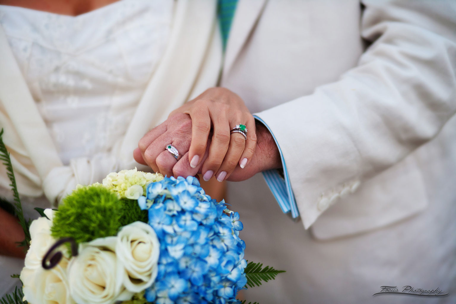 Bride and groom holding hands with flowers