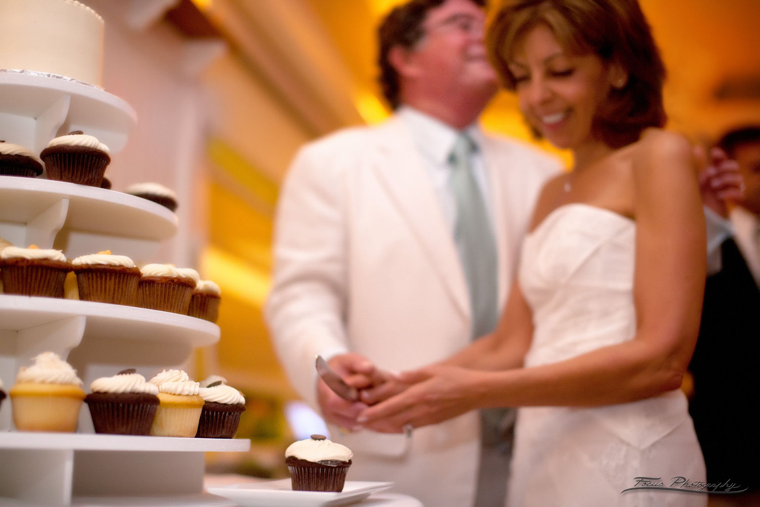 Bride and groom with cupcakes at Maine wedding