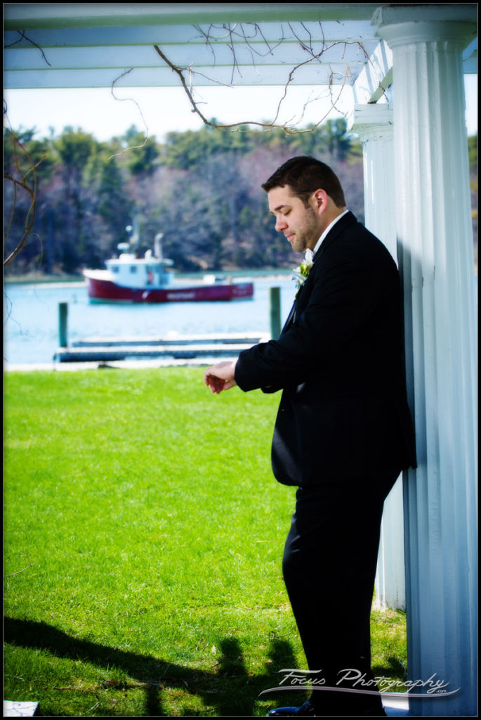 groom waiting by the harbor in Maine