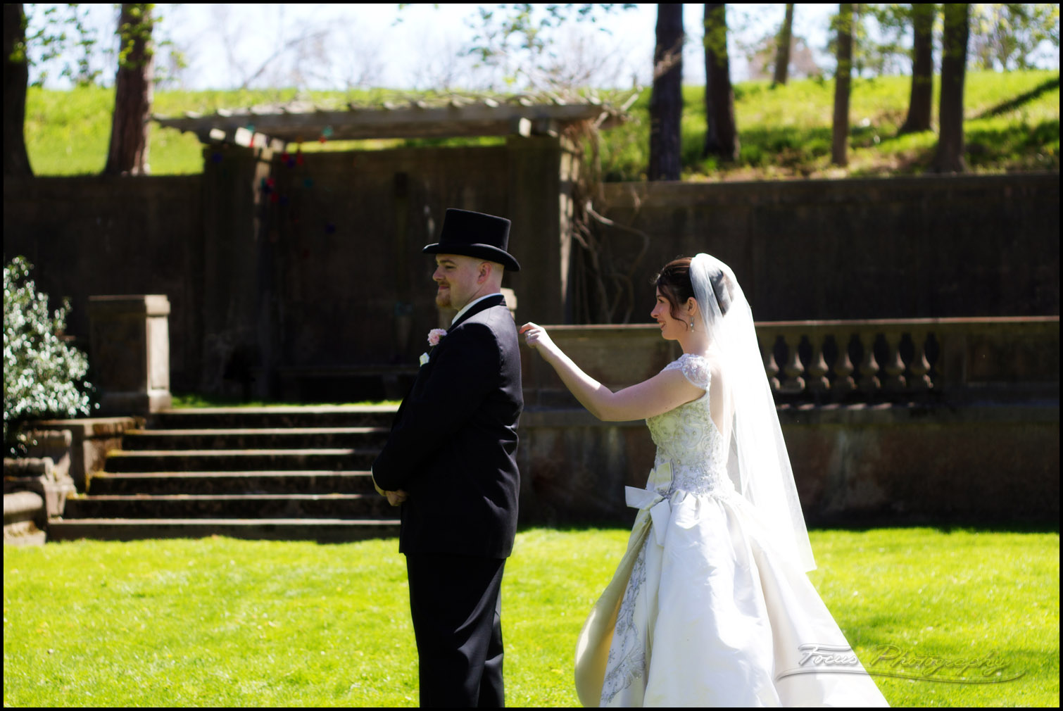 bride taps groom's shoulder during first glance reveal for wedding photography in Italian gardens