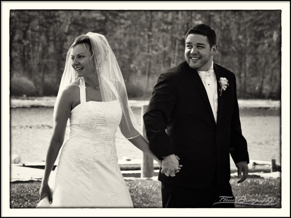 The bride and groom laughing after their wedding ceremony at the Nonantum Resort in Maine. Wedding Photography by Focus