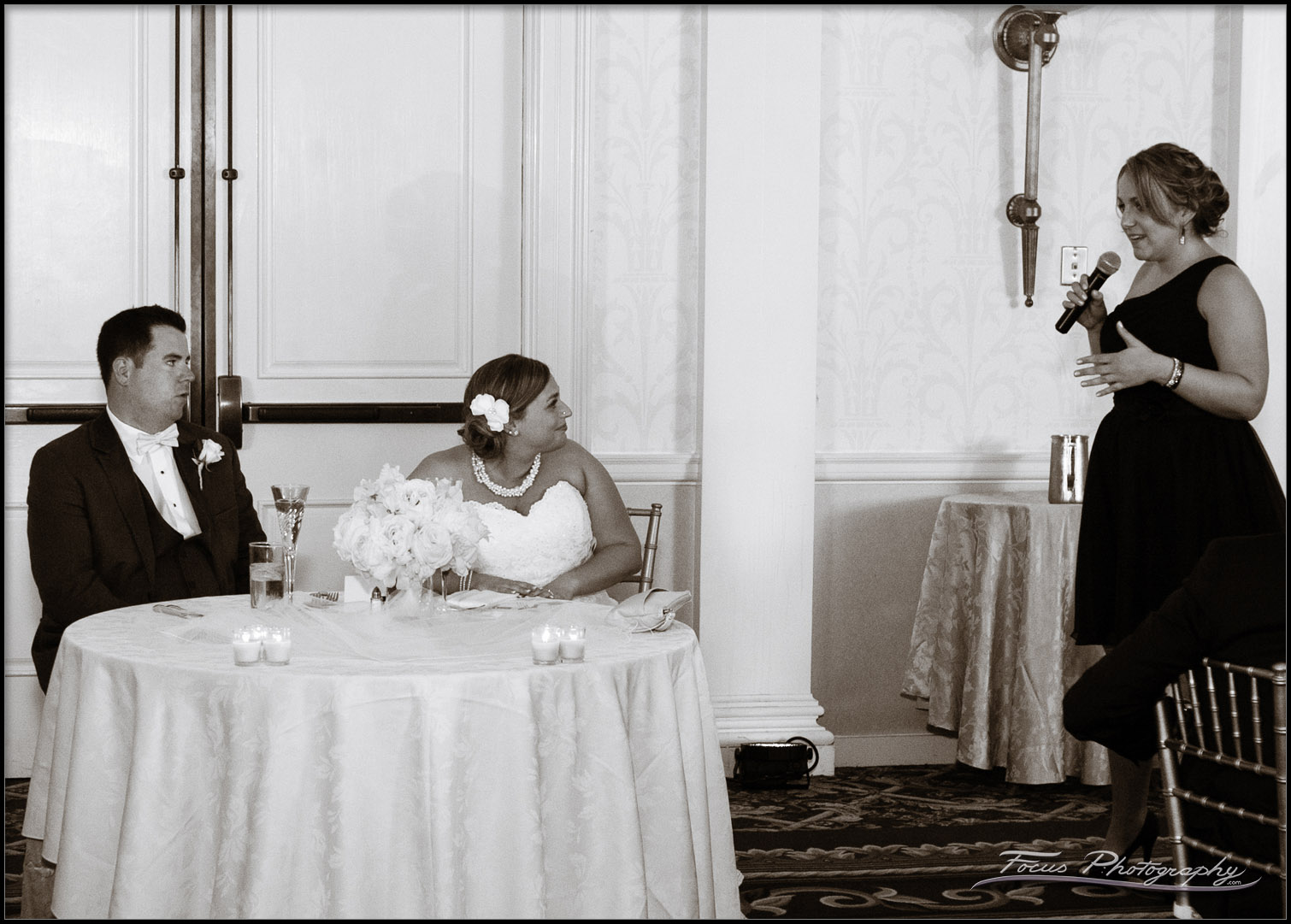 Black and White image of toast being given by Maid of Honor
