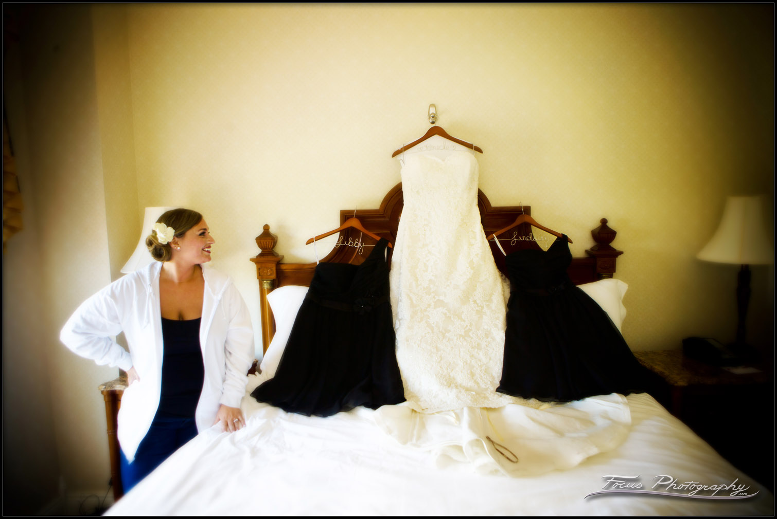 Bride admiring her dress choices.