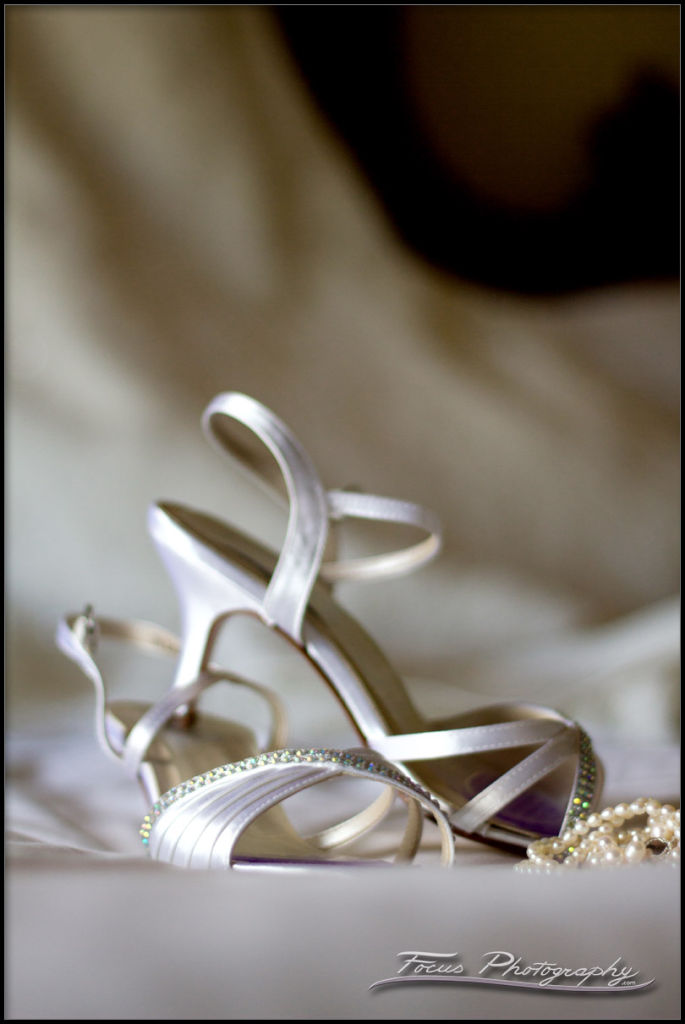 shoes and jewelry on wedding gown