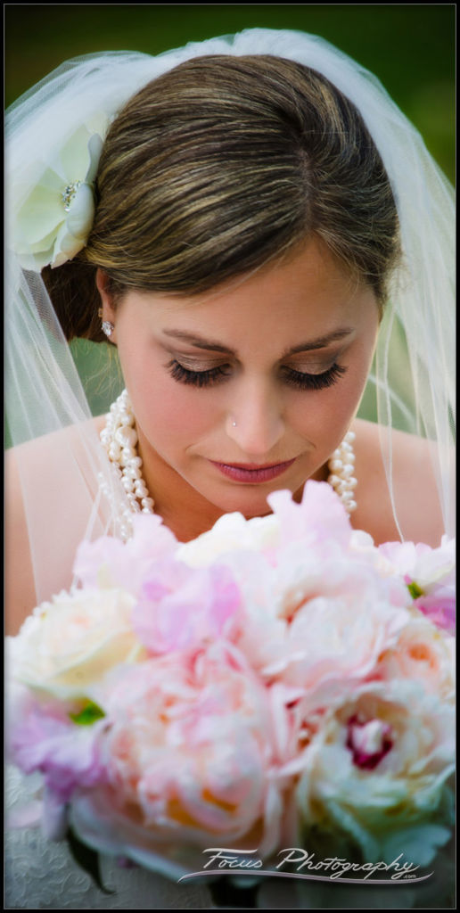 Beautiful bride admires her bridal bouquet