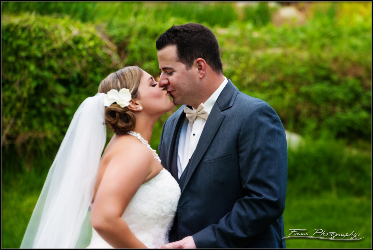 a kiss during wedding photos
