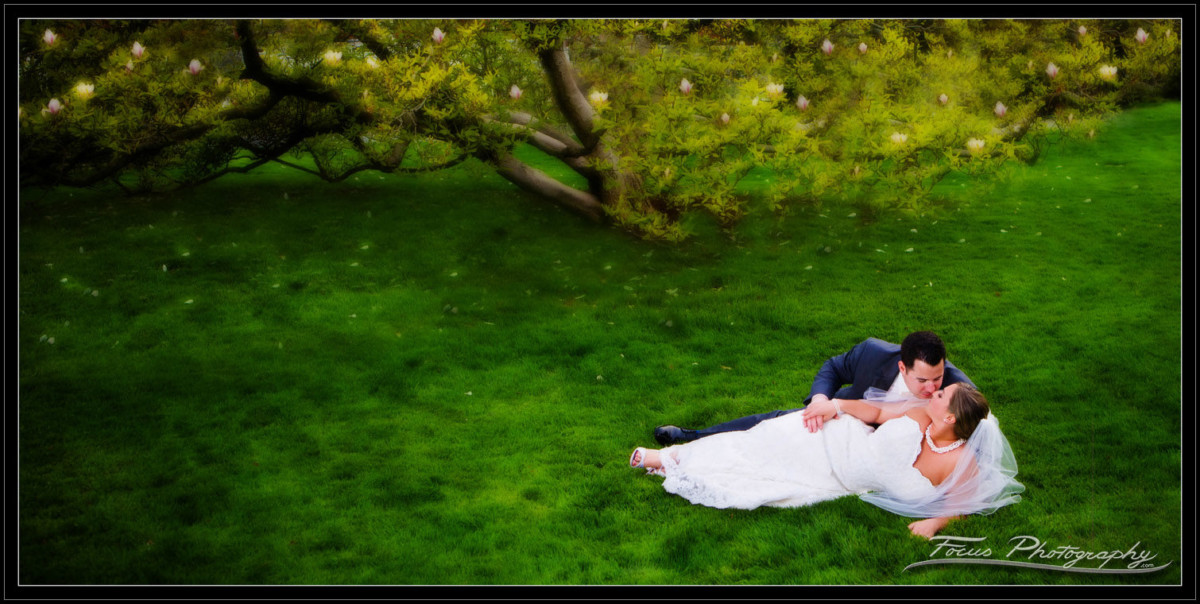 bride and groom in the garden at the Wentworth by the sea in New Castle, New Hampshire. Wedding photographers Focus Photography