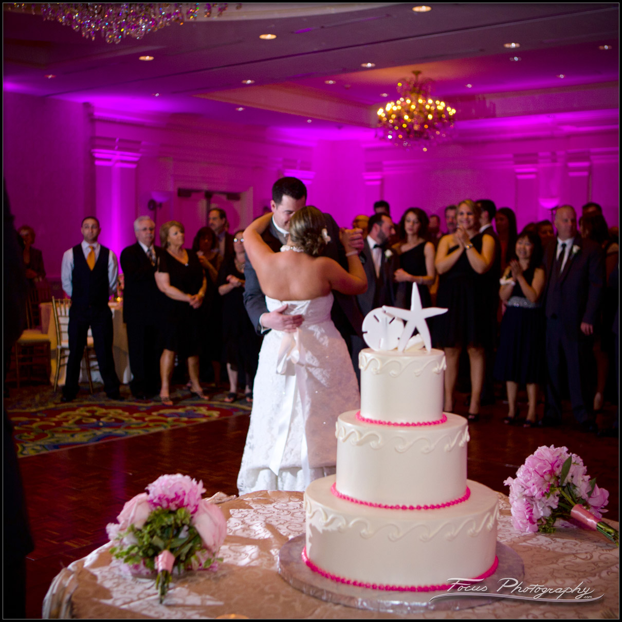 Bride and Groom dance with Wedding Cake