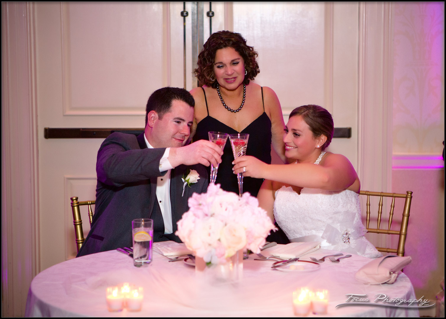 Bride and Groom toast while mom watches