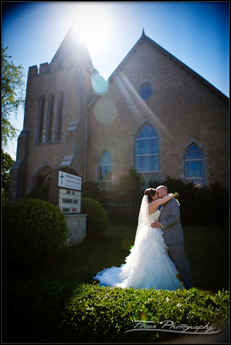 Bride and groom in the sunlight outside Deering community church at Maine wedding - photography by Focus