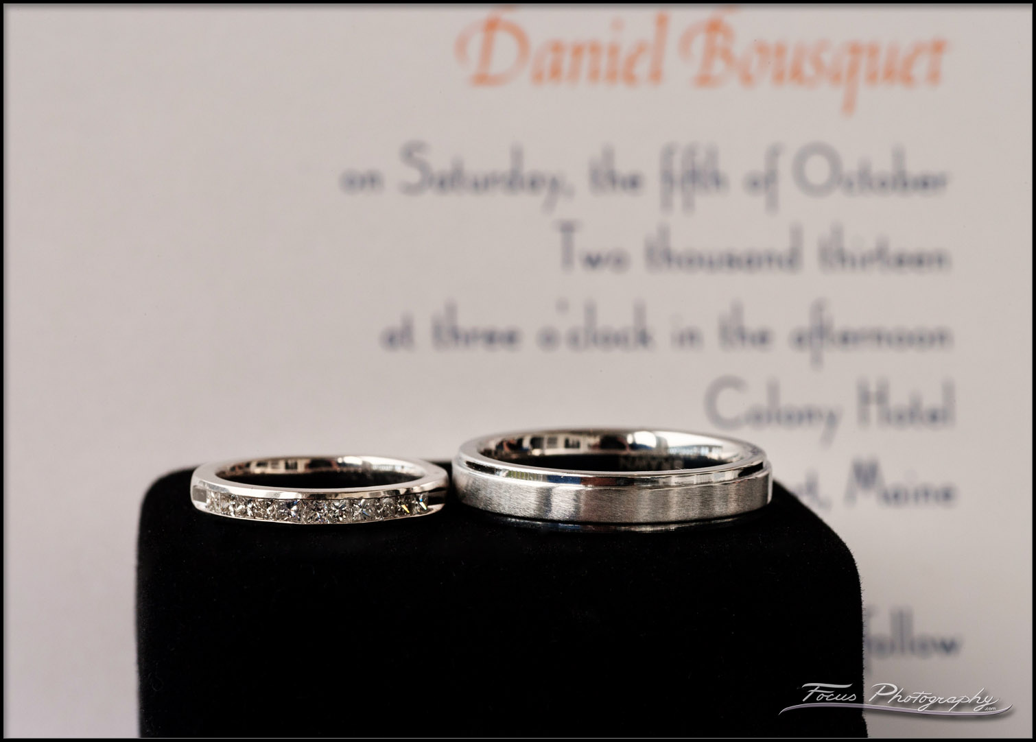 wedding bands in front of invite
