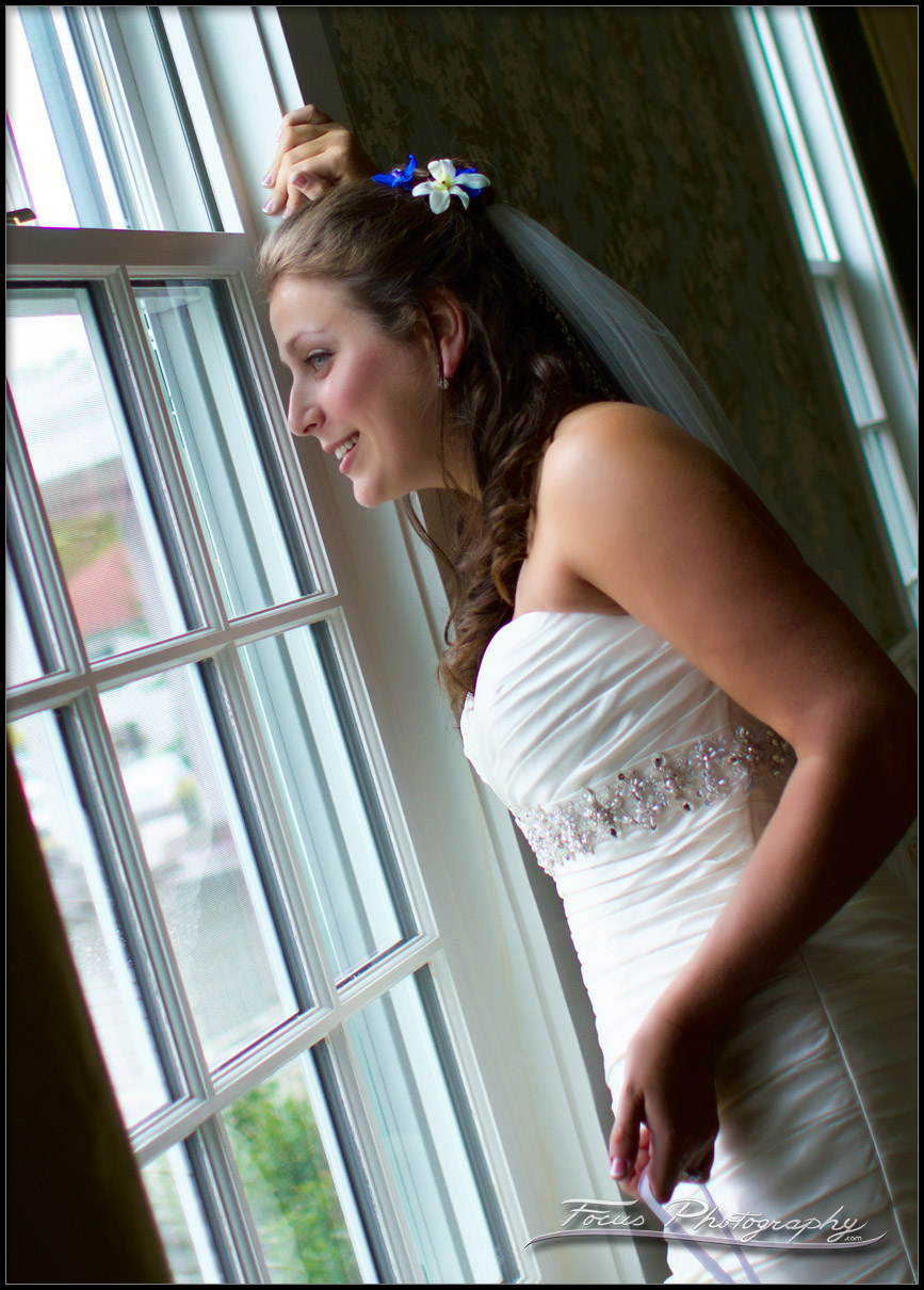 bride looks out window at Colony Hotel Wedding