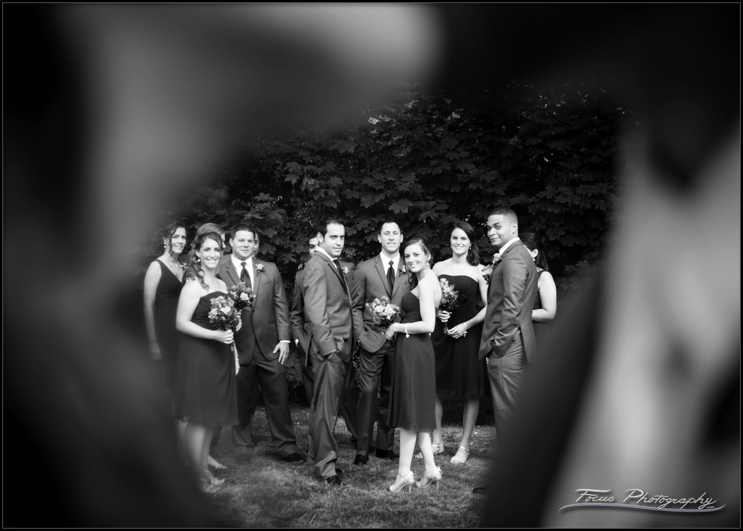 Wedding party viewed through kiss at Colony Hotel in Maine