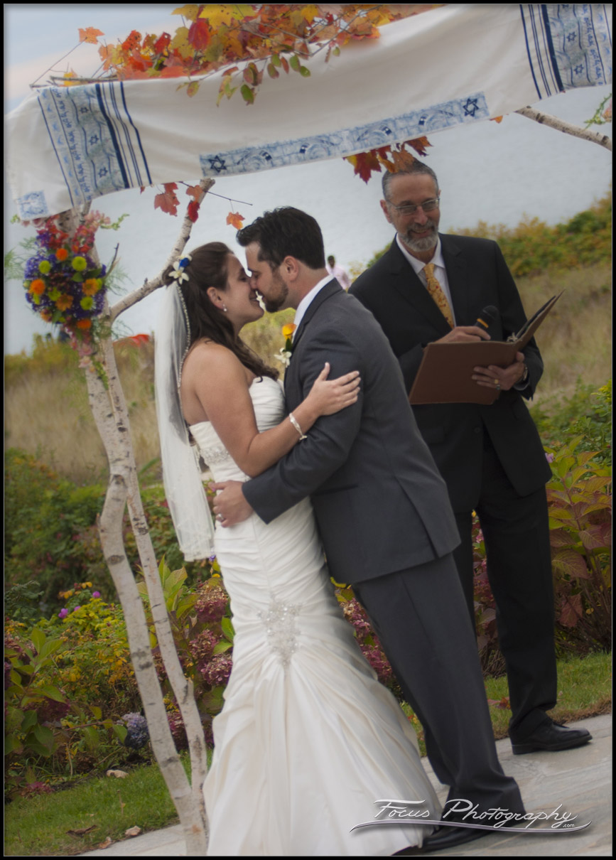 couple kiss at end of Wedding ceremony at  Colony Hotel in Kennebunkport, Maine