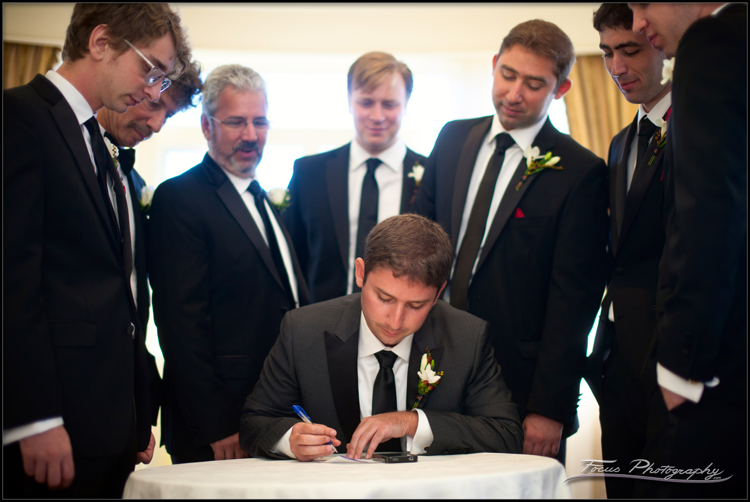 groom signs ketubah at wentworth wedding