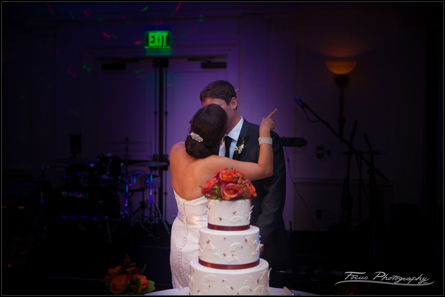 low light kiss in front of cake at wentworth by the sea