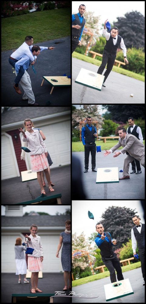 Wedding guests play cornhole during the cocktail hour