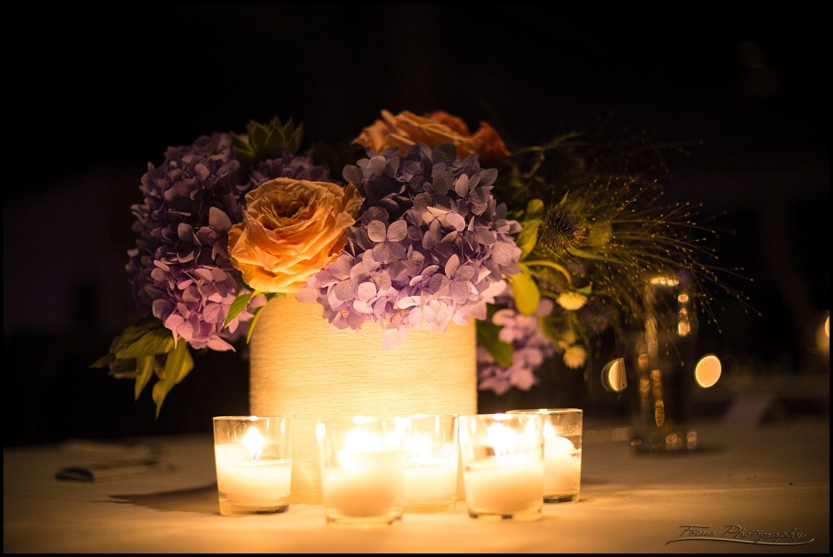 flowers illuminated by candles at wedding