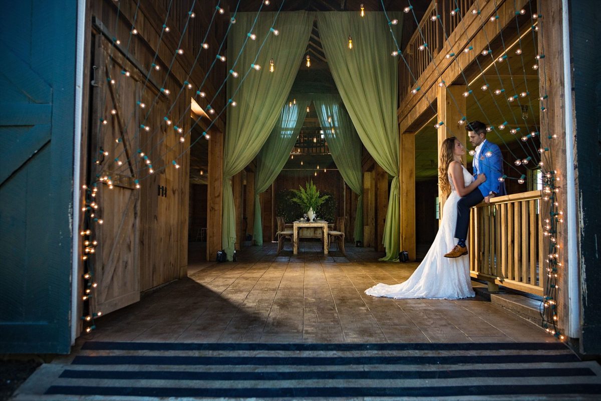 bride and groom in barn