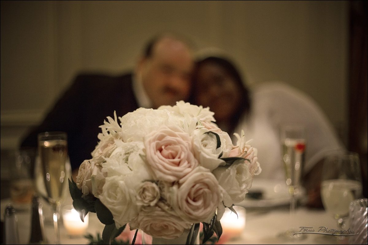 couple behind bouquet