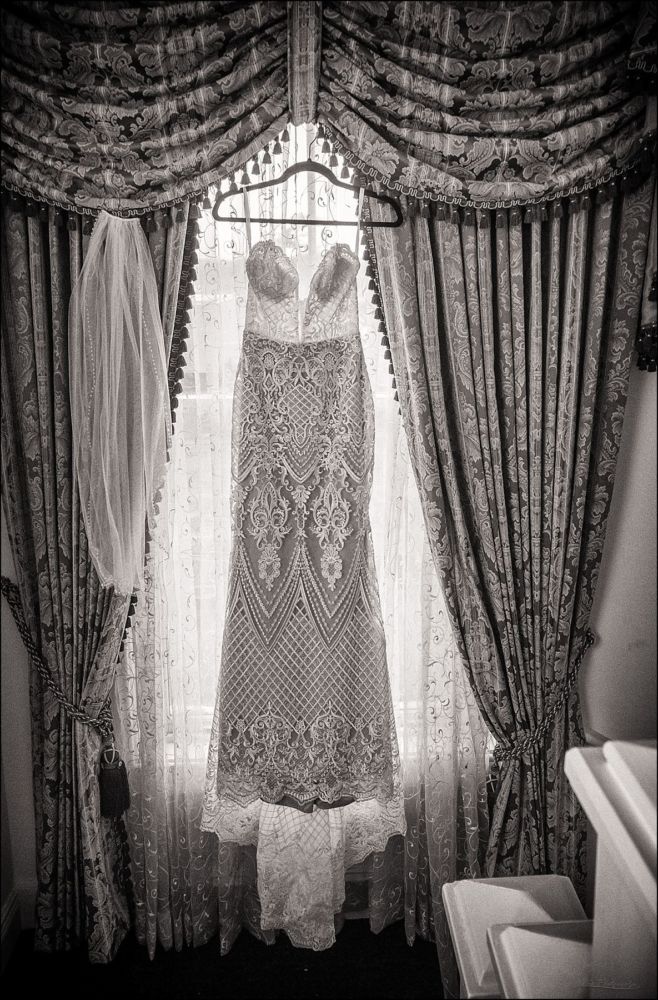 Wentworth by the Sea Wedding Pictures dress and veil hanging in window