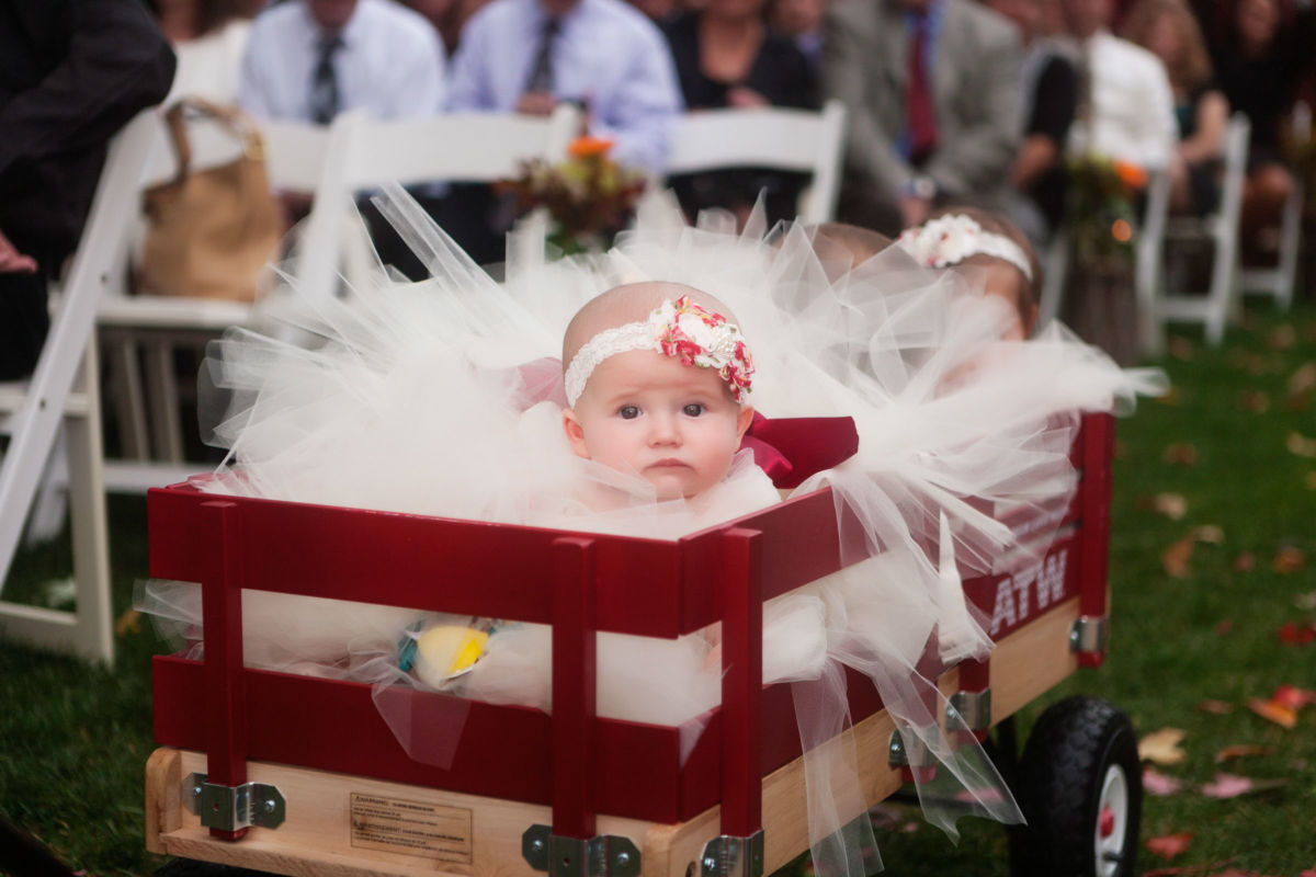Red Barn Wedding, baby arriving to ceremony in wagon