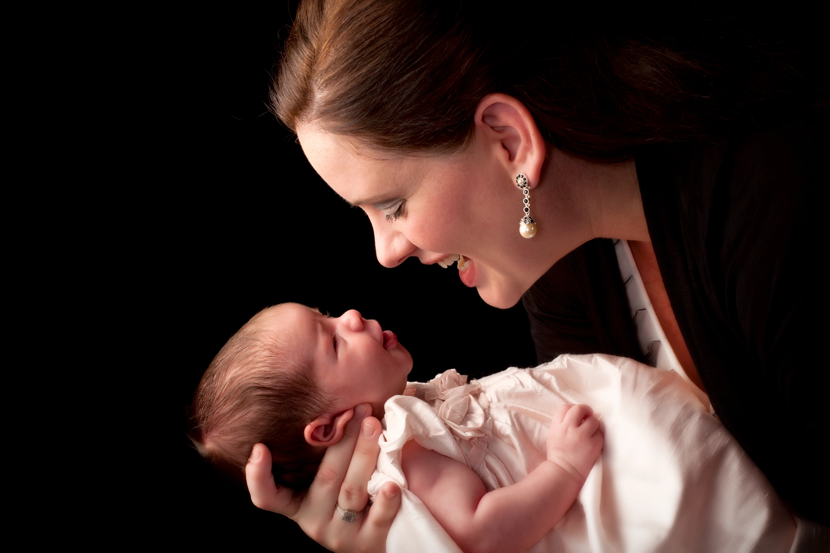 Mother holds baby in newborn portrait