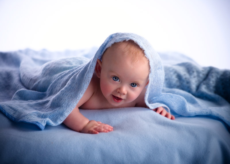 Newborn baby photo in the studio on blue blanket