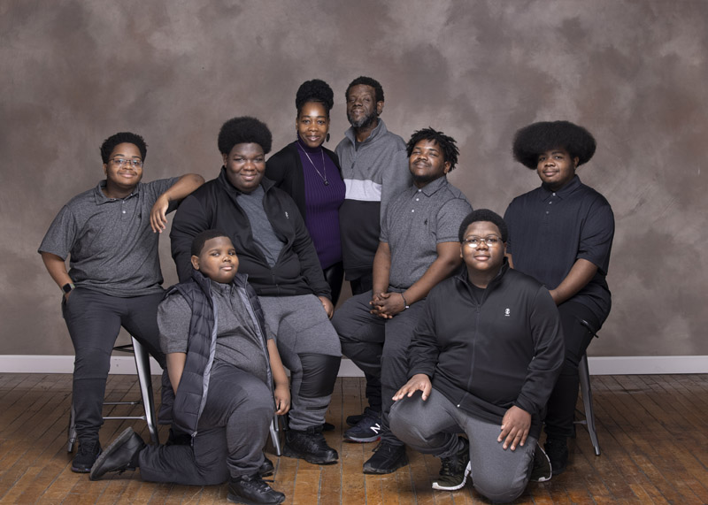 family portrait taken in maine photography studio of black family and their six boys