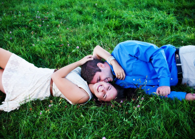 playful image of couple laughing in the grass