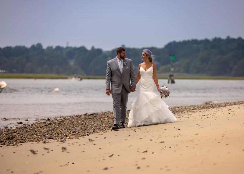 wedding couple walks on sand on Drake's Island in Wells, Maine