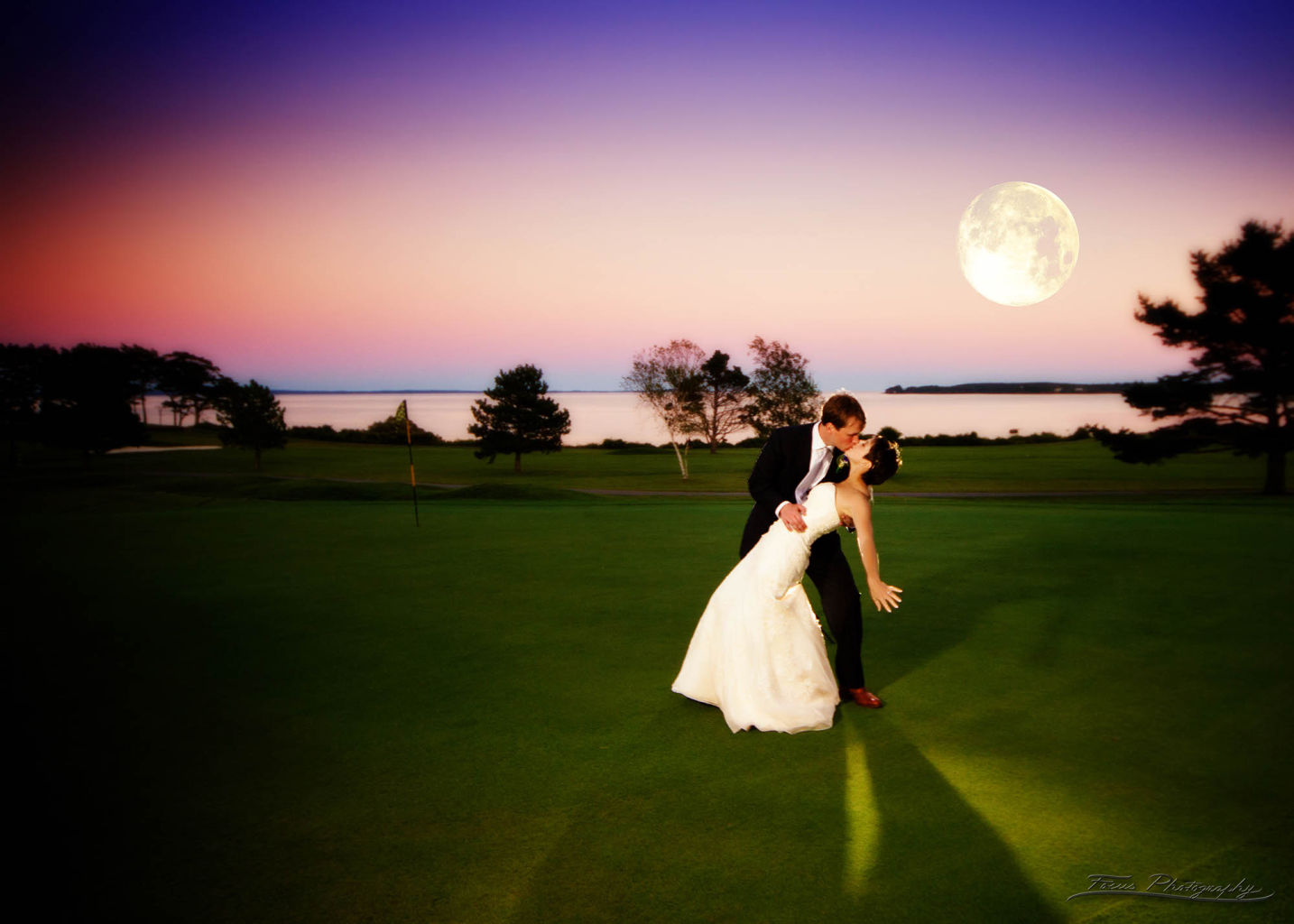 The bride and groom dance in the moonlight at the Samoset Resort