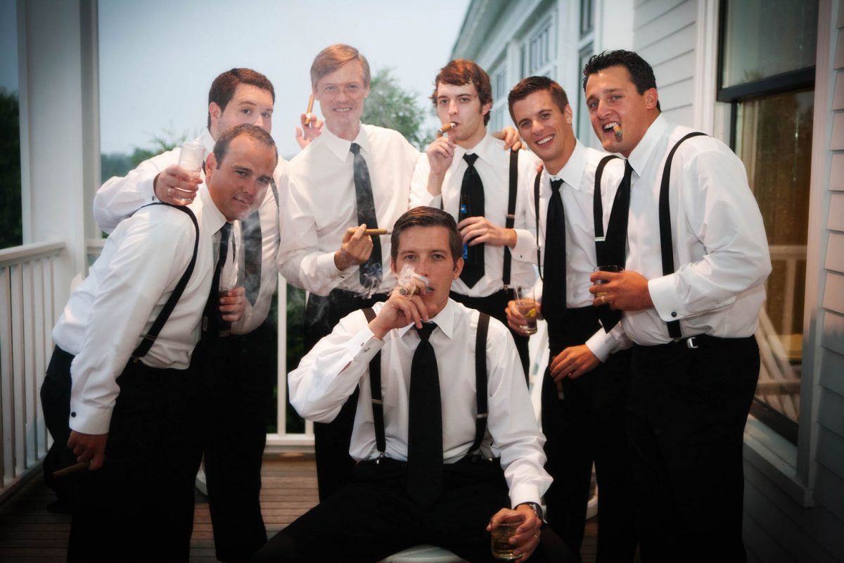 the men smoke cigars during the wedding reception at the Wentworth by the Sea